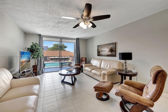 living room with floor to ceiling windows and ceiling fan