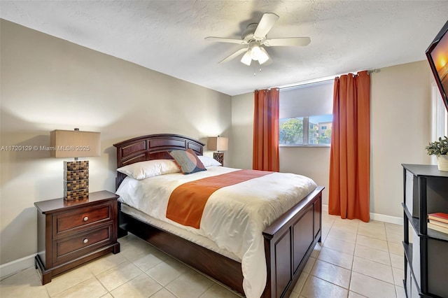 tiled bedroom featuring ceiling fan and a textured ceiling