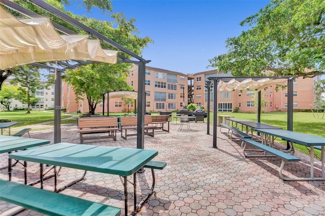 view of community featuring a pergola and a yard