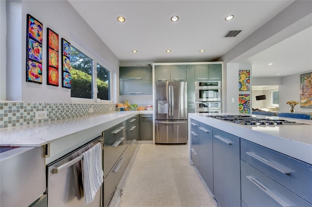 kitchen featuring stainless steel appliances and backsplash