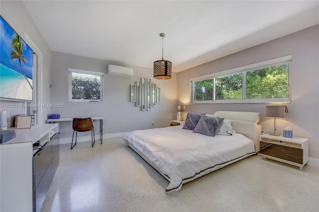 bedroom with an AC wall unit and multiple windows