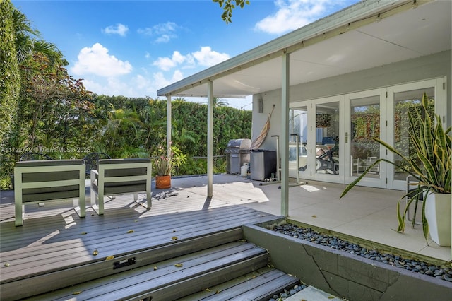 deck featuring french doors and a grill