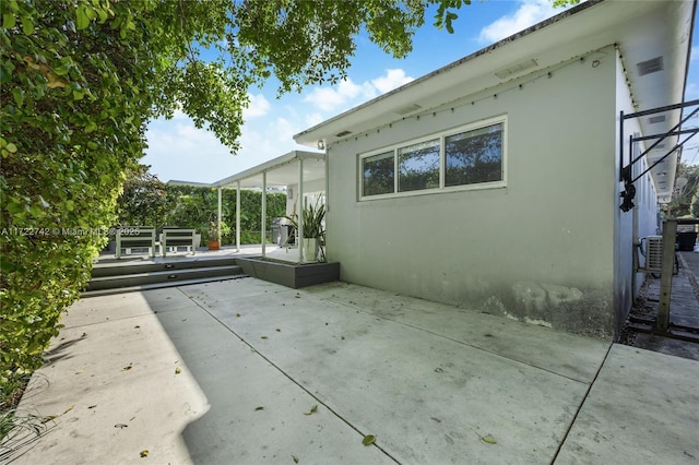 view of side of home with a patio