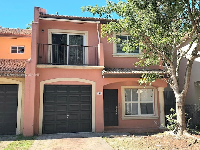 view of front of house featuring a balcony and a garage