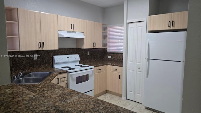 kitchen with sink, dark stone countertops, white appliances, decorative backsplash, and light brown cabinetry