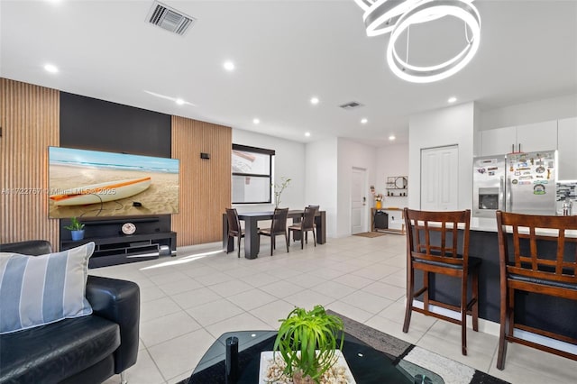 living room featuring light tile patterned flooring and a chandelier