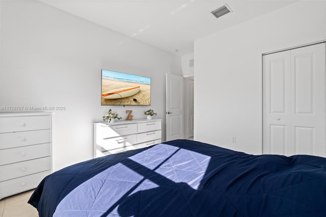 tiled bedroom featuring a closet