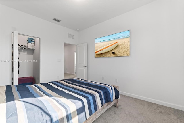 bedroom featuring carpet, a walk in closet, and a closet