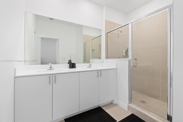 bathroom featuring vanity, tile patterned floors, and an enclosed shower