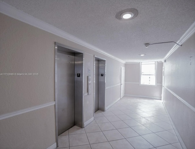 hall featuring light tile patterned flooring, ornamental molding, and elevator