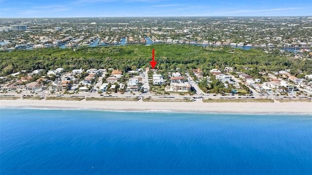 bird's eye view with a water view and a beach view