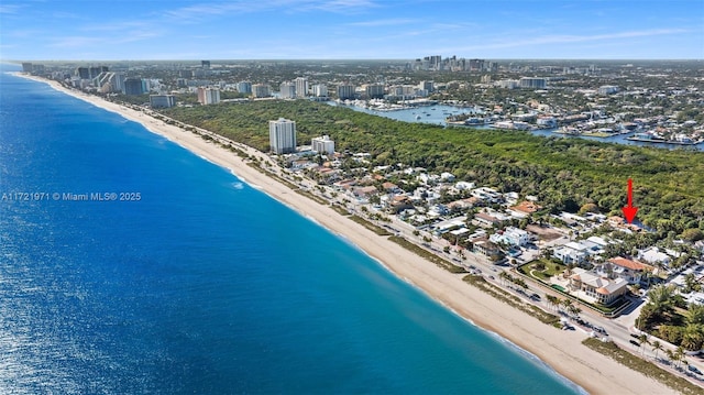 aerial view with a water view and a beach view