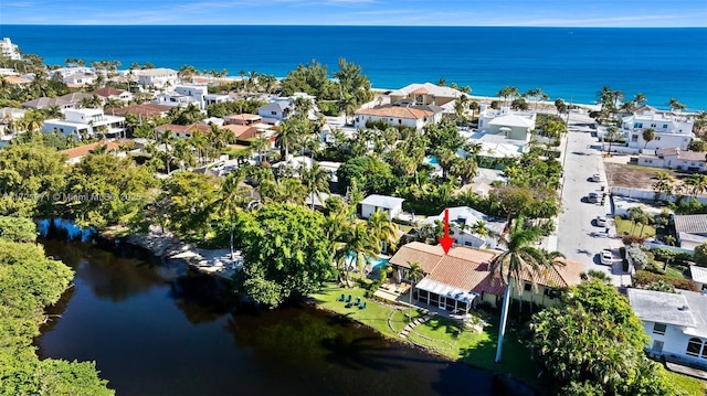 birds eye view of property with a water view