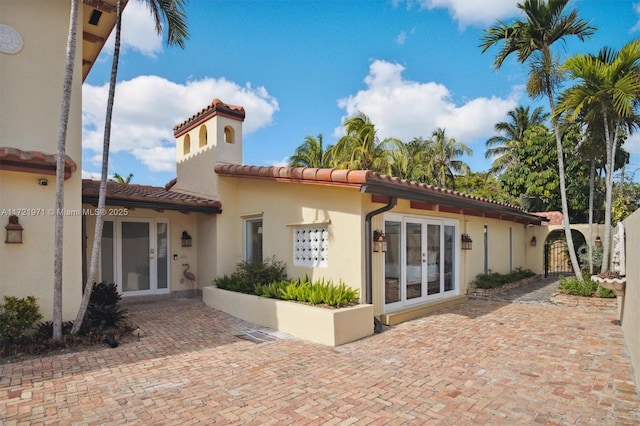 back of property featuring french doors and a patio