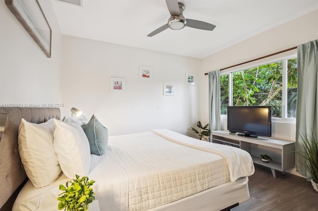 bedroom with ceiling fan and dark wood-type flooring