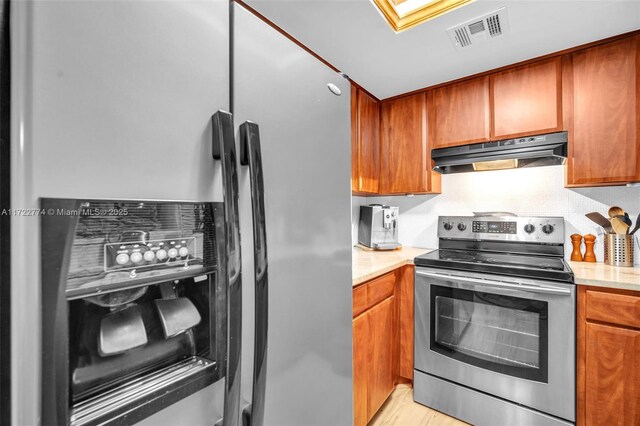 kitchen with sink, crown molding, light stone countertops, and appliances with stainless steel finishes