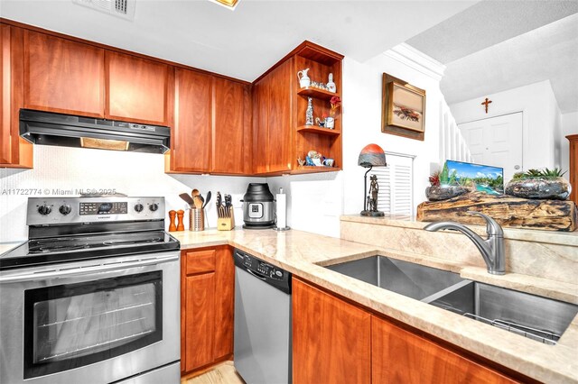 kitchen with appliances with stainless steel finishes and light stone counters