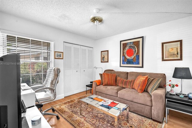 office space with hardwood / wood-style floors and a textured ceiling