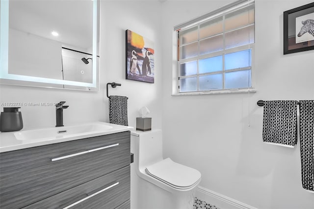 bathroom featuring walk in shower, vanity, and toilet