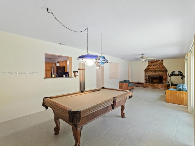 playroom with a fireplace, ceiling fan, and pool table