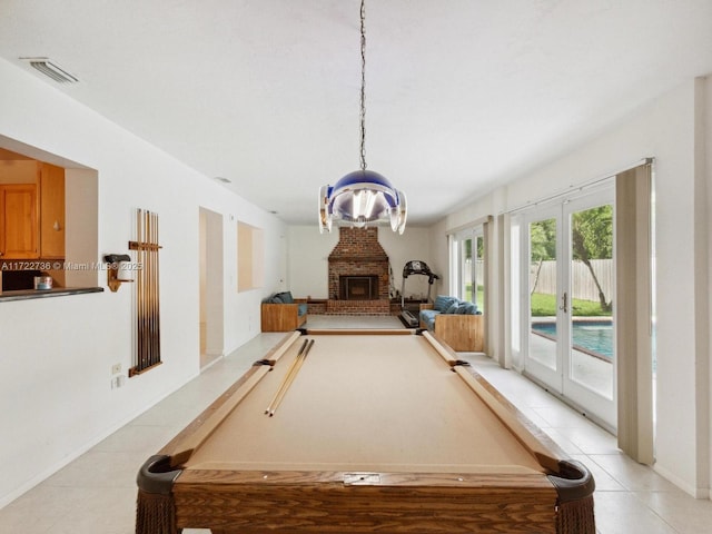 recreation room with a fireplace, french doors, light tile patterned floors, and pool table