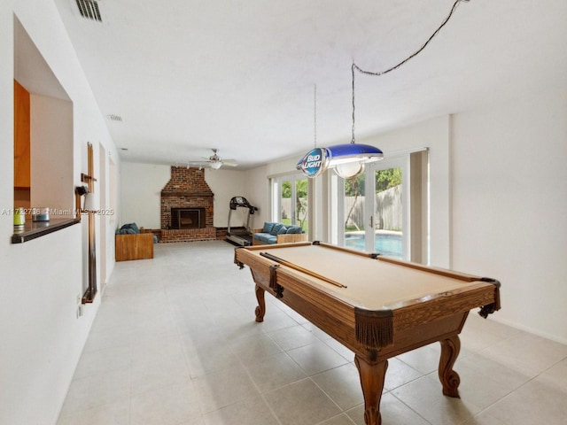 game room featuring ceiling fan, billiards, and a brick fireplace