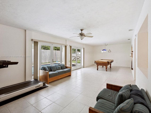 living room featuring light tile patterned floors, ceiling fan, and pool table