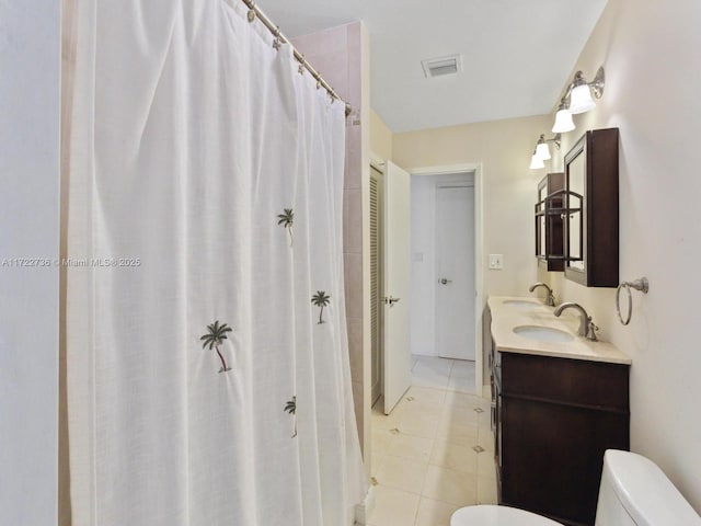 bathroom with tile patterned floors, vanity, and toilet