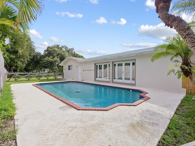 view of swimming pool featuring a patio area and french doors