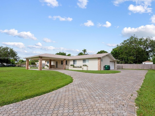 ranch-style home featuring a garage and a front lawn