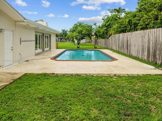 view of swimming pool with a yard and a patio