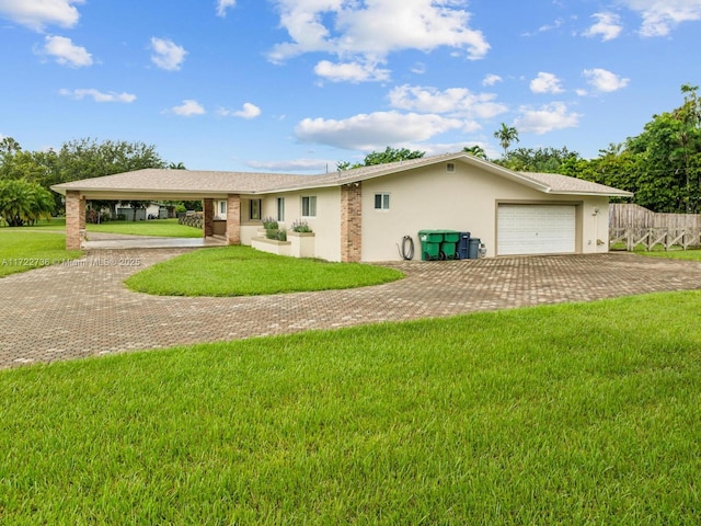 single story home with a carport, a garage, and a front yard