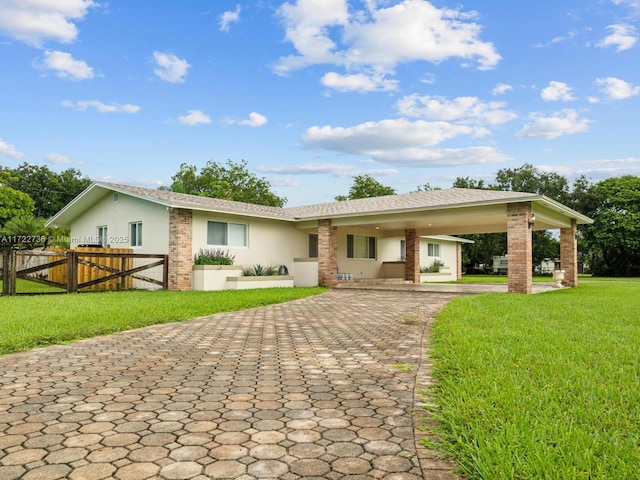 back of house featuring a yard and a carport