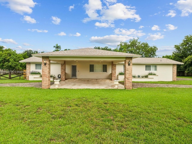 back of house with a yard and a patio