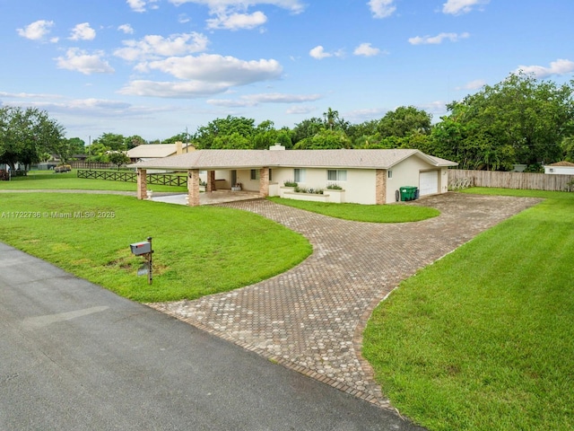 ranch-style home with a front yard and a garage