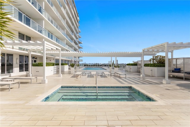 view of pool featuring a pergola, a patio, and a hot tub