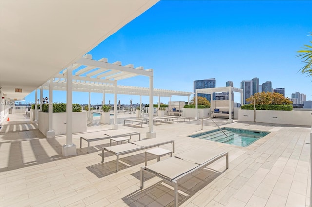 view of pool with a pergola, a patio area, and a hot tub