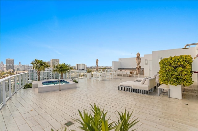 view of patio / terrace featuring an in ground hot tub