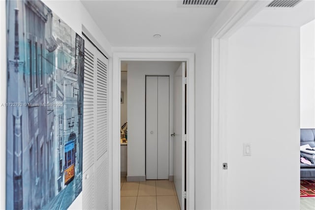 hall featuring light tile patterned floors