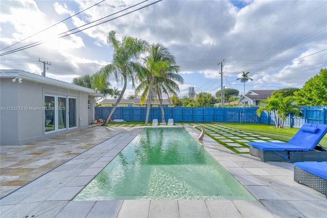 view of swimming pool with a yard and a patio area