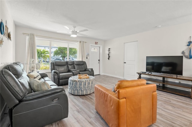 living room featuring ceiling fan and light hardwood / wood-style floors