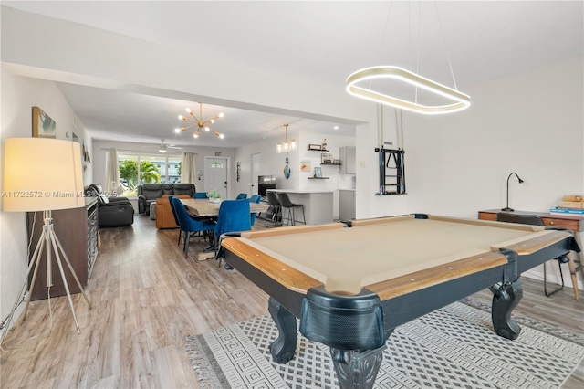 game room with hardwood / wood-style floors, pool table, and a chandelier