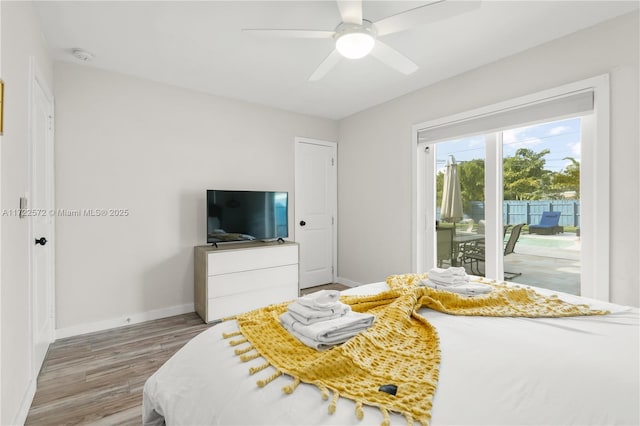 bedroom with access to exterior, ceiling fan, and wood-type flooring