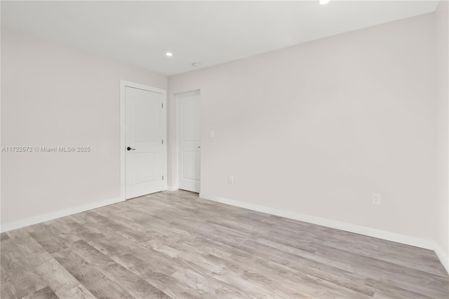 empty room with light hardwood / wood-style floors