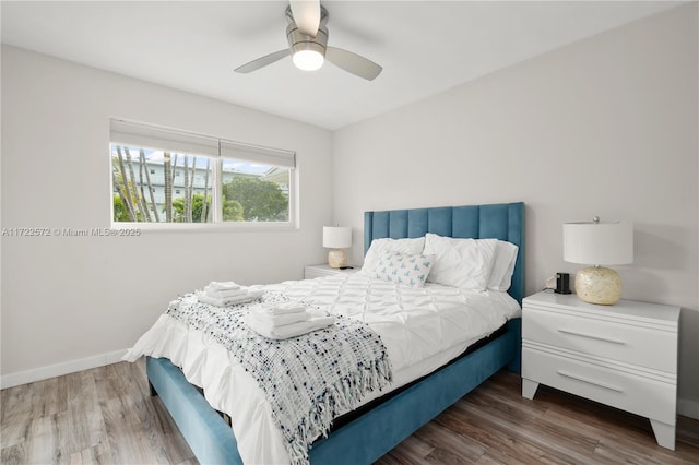 bedroom with dark hardwood / wood-style flooring and ceiling fan