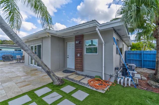 exterior space featuring a front yard and a patio