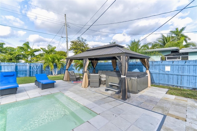 view of patio featuring a gazebo and a hot tub