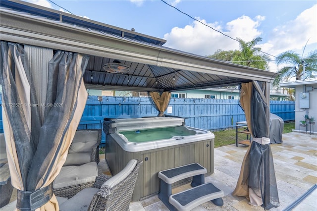 view of patio featuring a gazebo and a hot tub