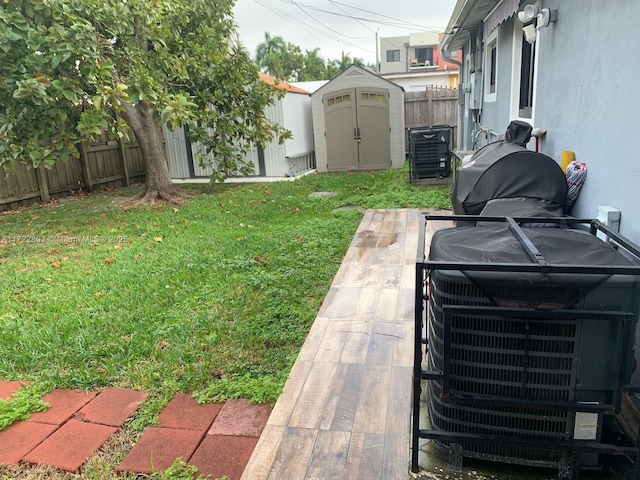 view of yard featuring a patio area, a shed, and central air condition unit