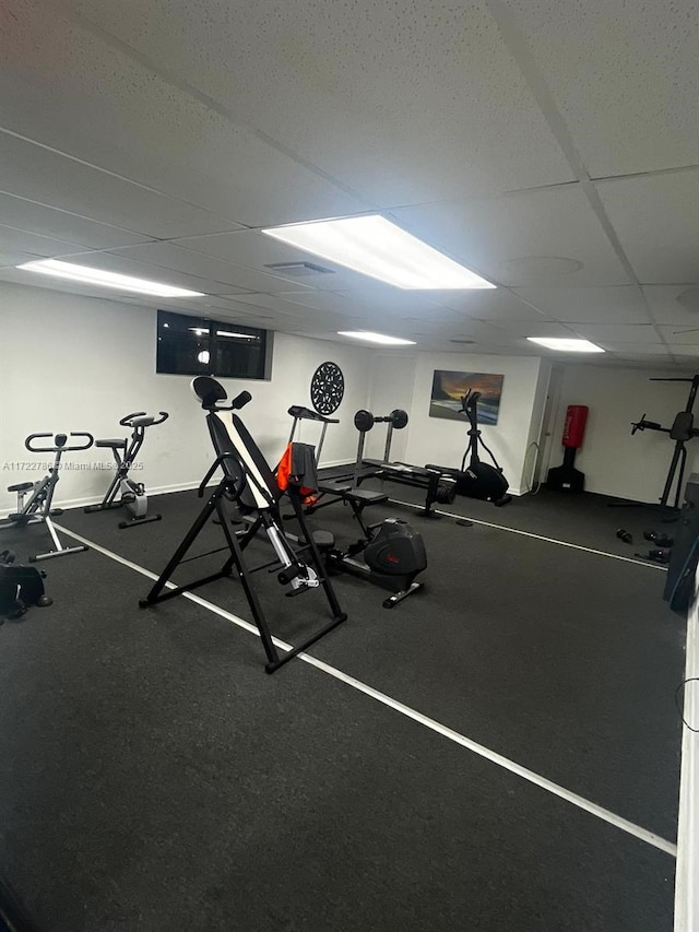 workout area with a paneled ceiling